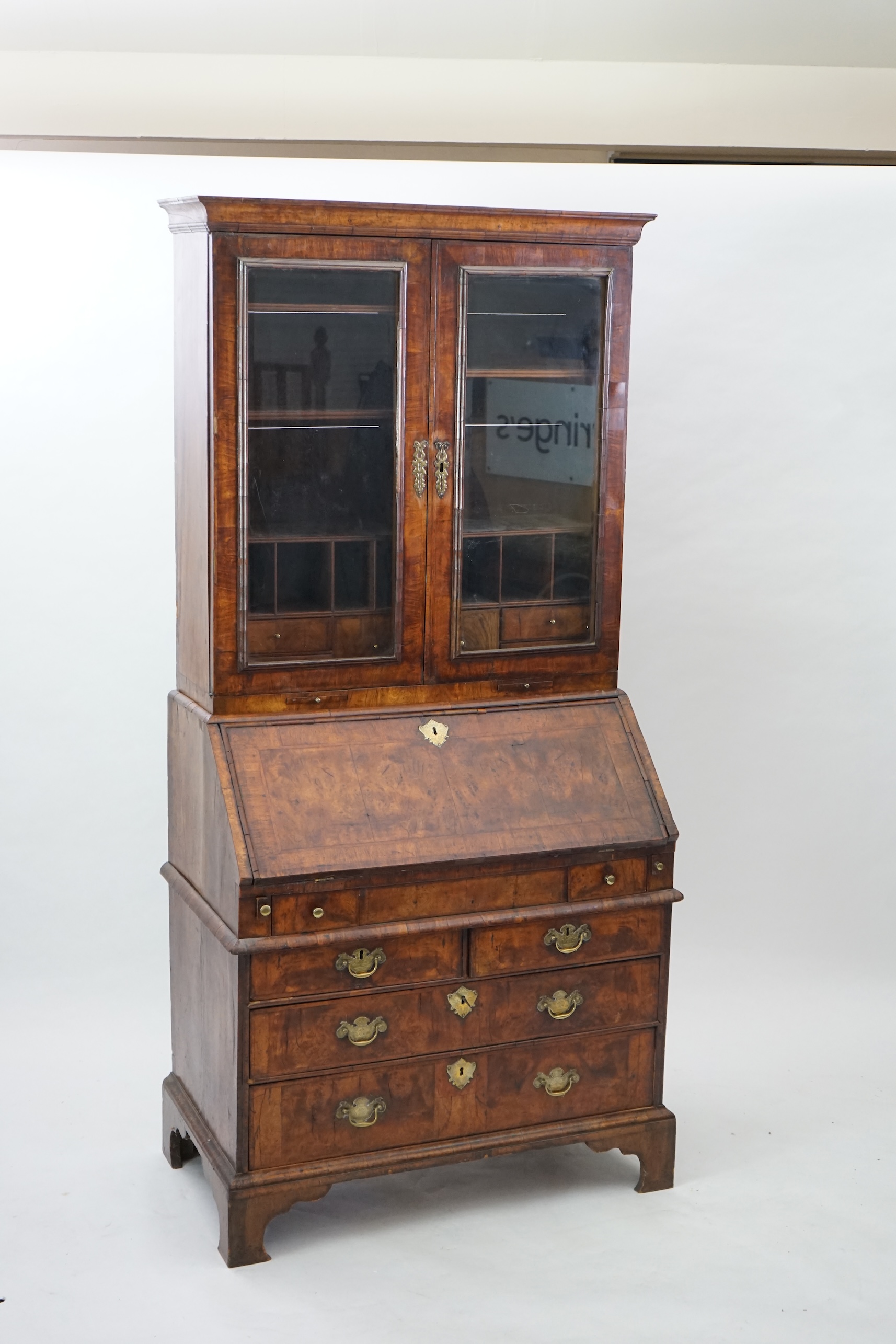 An early 18th century walnut bureau bookcase